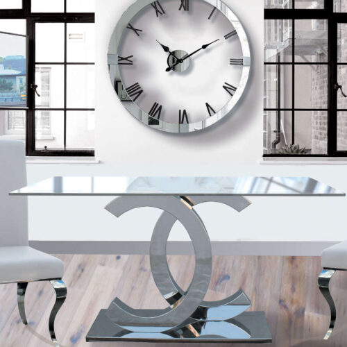 Mesa comedor acero cromado con tapa cristal transparente.